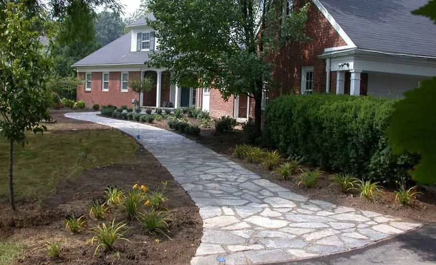 Natural flagstone walk — Irregular flagstone set to a curved path with planting drawn up to both edges.